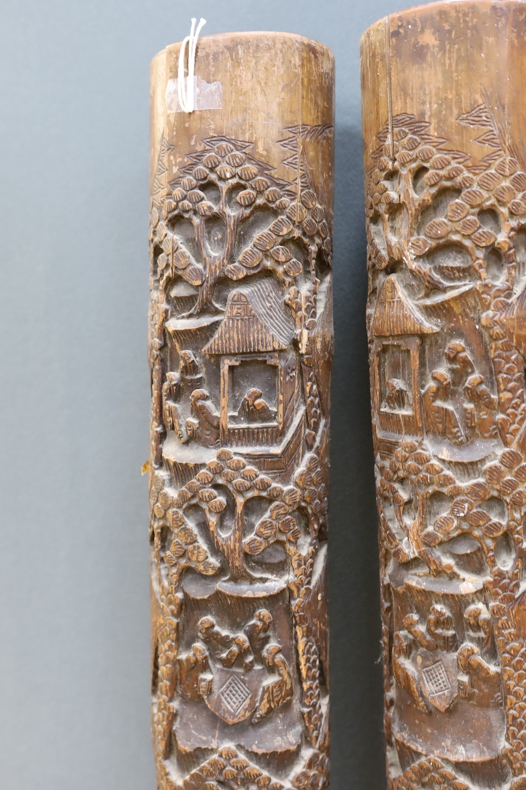A pair of early 20th century Chinese carved bamboo chutes, 70cm